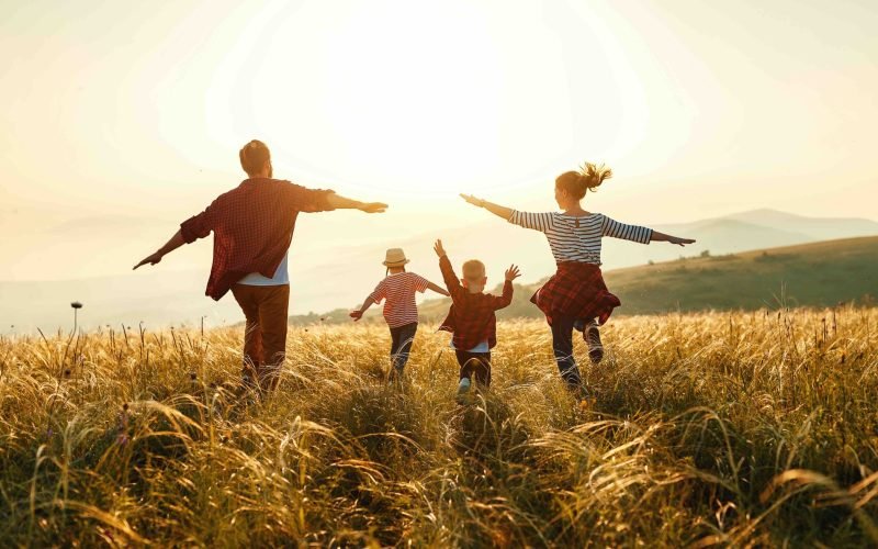 Happy family: mother, father, children son and  daughter on nature  on sunset